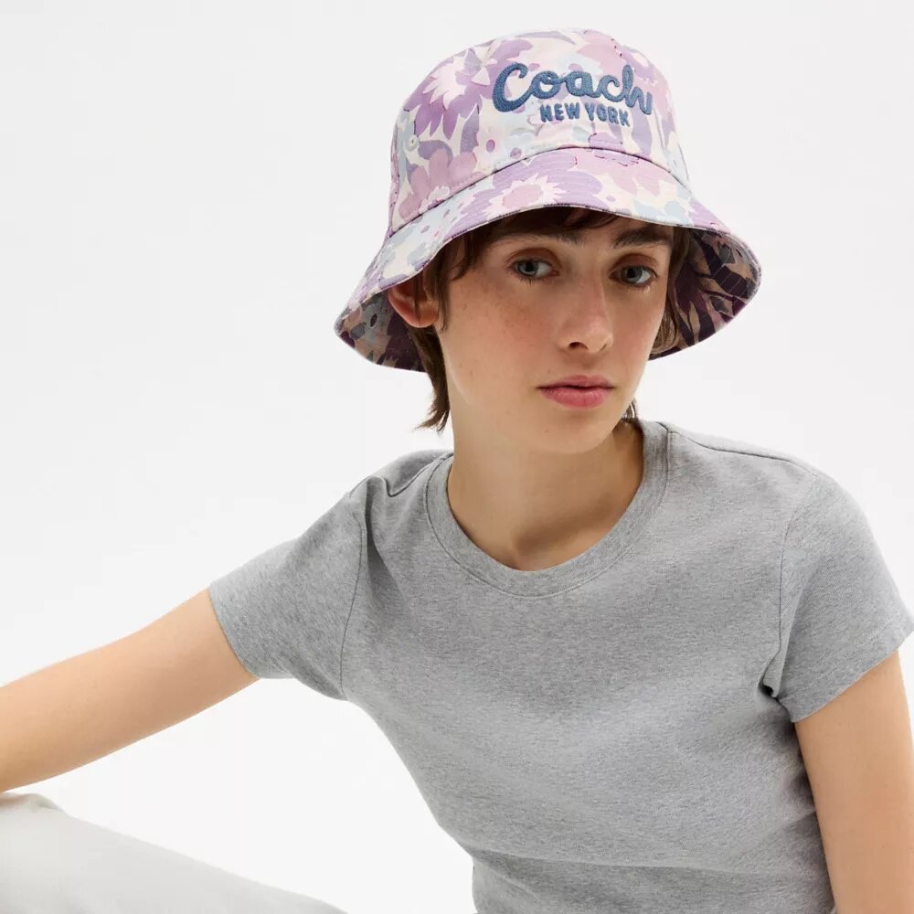 Bucket-hatt med Coach-skrift och blommönster