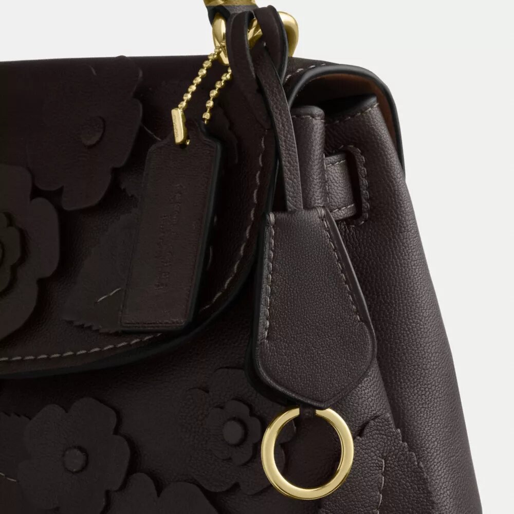 Emory-väska med handtag och blommig applikation