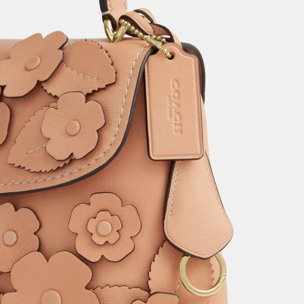 Emory-väska med handtag och blommig applikation