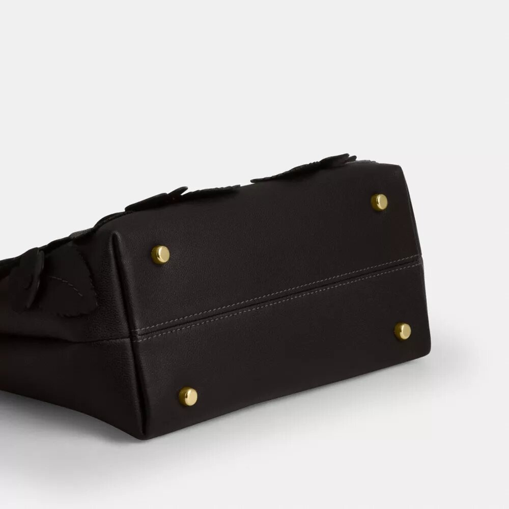 Emory-väska med handtag och blommig applikation