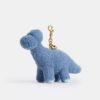 Rexy 10-årsdag Buddy Dinosaur-väsksmycke i shearling