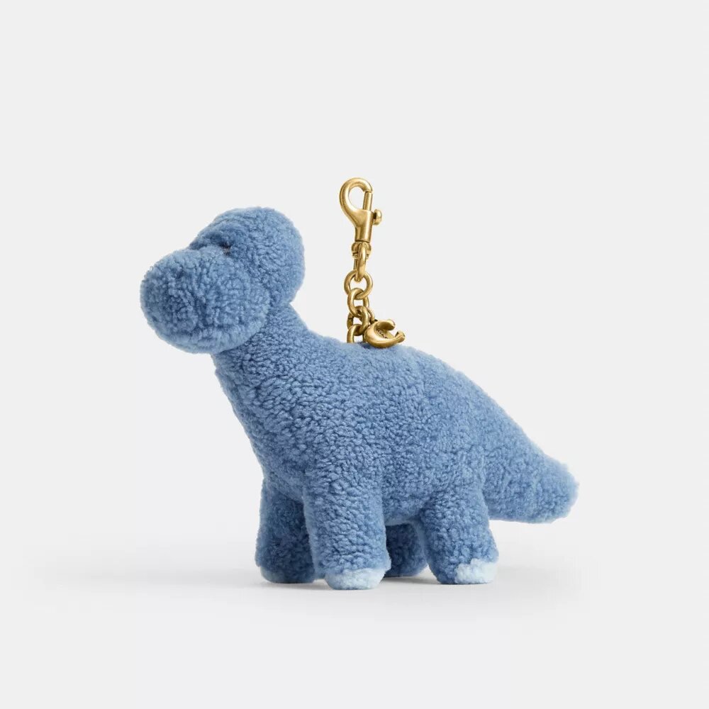 Rexy 10-årsdag Buddy Dinosaur-väsksmycke i shearling