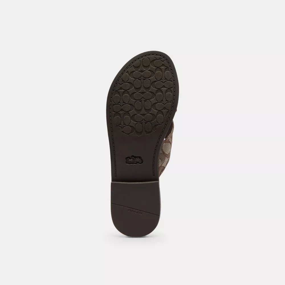 Sandaler med korsade spännen i signaturjacquard