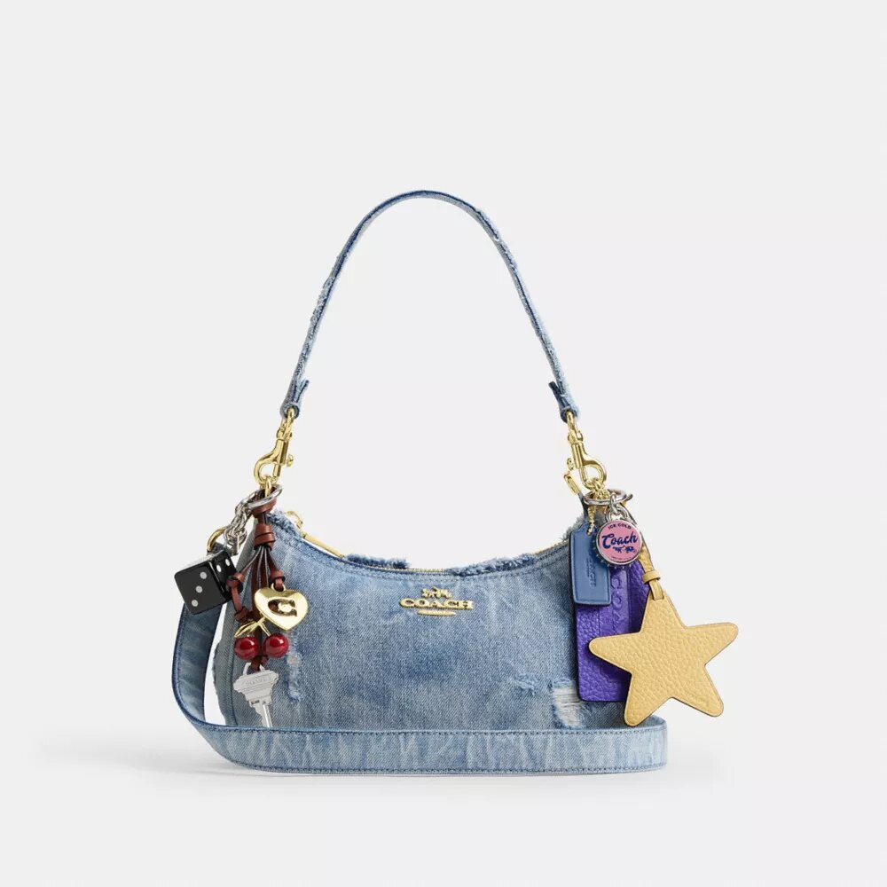 Teri axelremsväskor i sliten denim med smycken