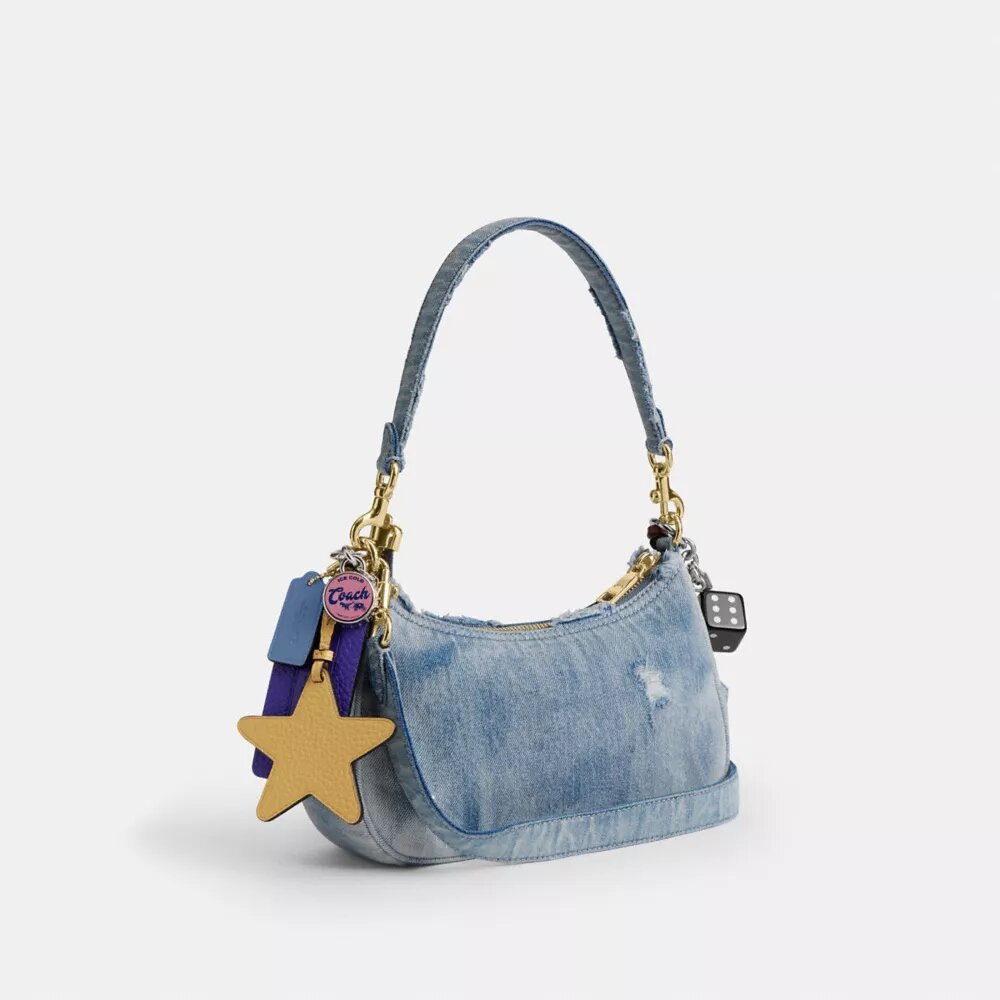 Teri axelremsväskor i sliten denim med smycken