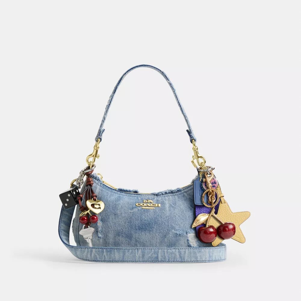 Teri axelremsväskor i sliten denim med smycken