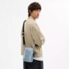 Tristan crossbody-väska 14 i den populära signaturdenimen med smycken